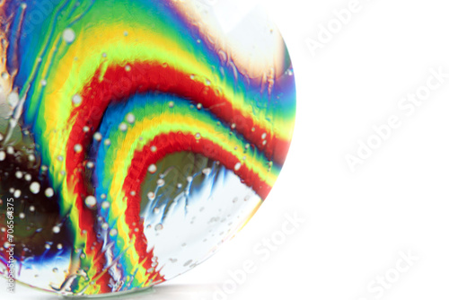 Optical abstract background of rainbow fabric with kinks and light effects in water drops.