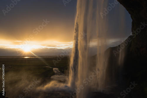 Scenic view of waterfall against sky during sunset at golden hour 