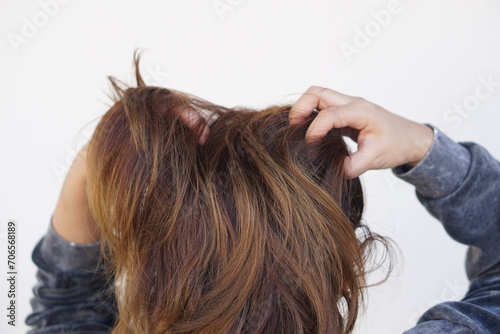 Woman use hands to scratch her itcy hair on head, isolated on white background. Concept, Hair health problems. Dandruff, fungus on scalp, allergic to shampoo or louse. 