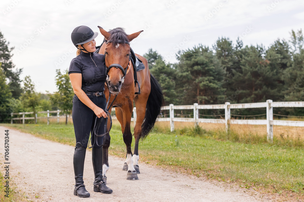 Female rider hand gently caressing beautiful thick red horse mane, close up shot. Equitation and animal lover concept. Female rider hand gently caressing beautiful thick red horse mane, close up shot. Equitation and animal lover concept.