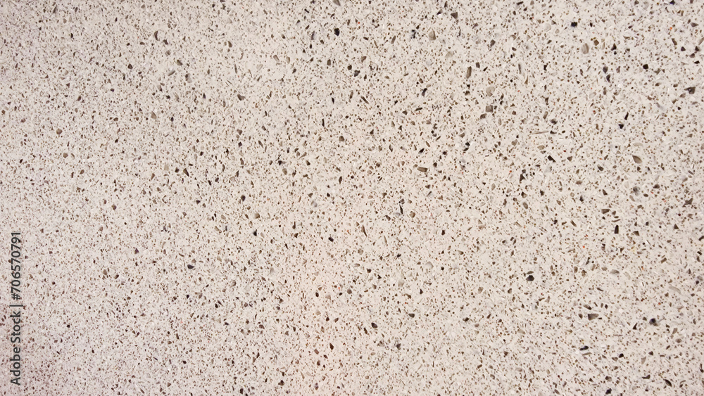Fototapeta premium texture of grainy quartz in beige sand color, closeup view. light white marble stone texture with splashes and marble chips. terrazzo background for furnishing furniture.