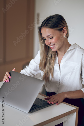 Long-haired young business woman at her working place