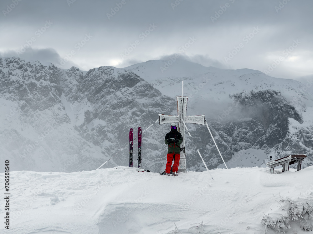 Skier on a snowy mountain top