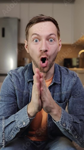Happy excited man waiting for surprise, rubbing hands against in anticipation of present. Vertical video.