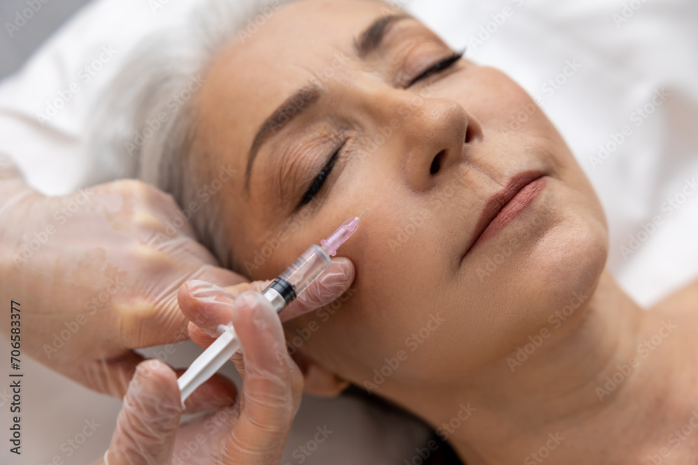 Woman having anti wrinkle filler injections to eye area Woman having anti wrinkle filler injections to eye area