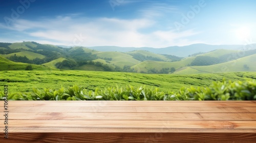 Wooden table top with blurred tea plantation landscape © Fay Melronna 