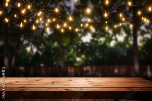 Wooden top table with bokeh light effect and blurred picnic background. Table top with copy space for product advertising.