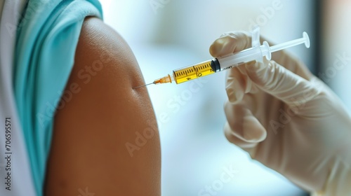 Close-up of a vaccine being administered to a patient's arm by a medical professional in a clinical setting photo