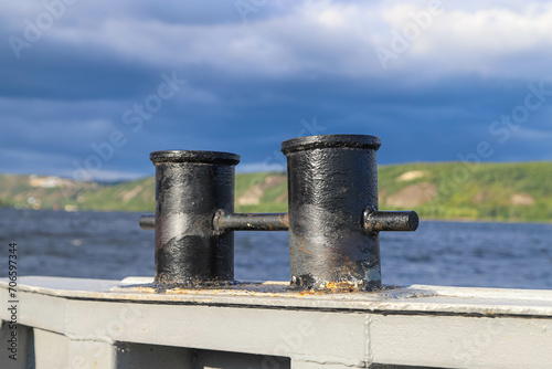 Old rusty double bitt bollard on a river boat photo