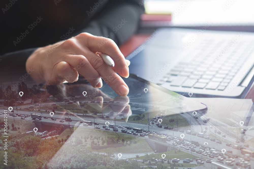 Obraz premium Businesswoman selects on a tablet instead of car location.