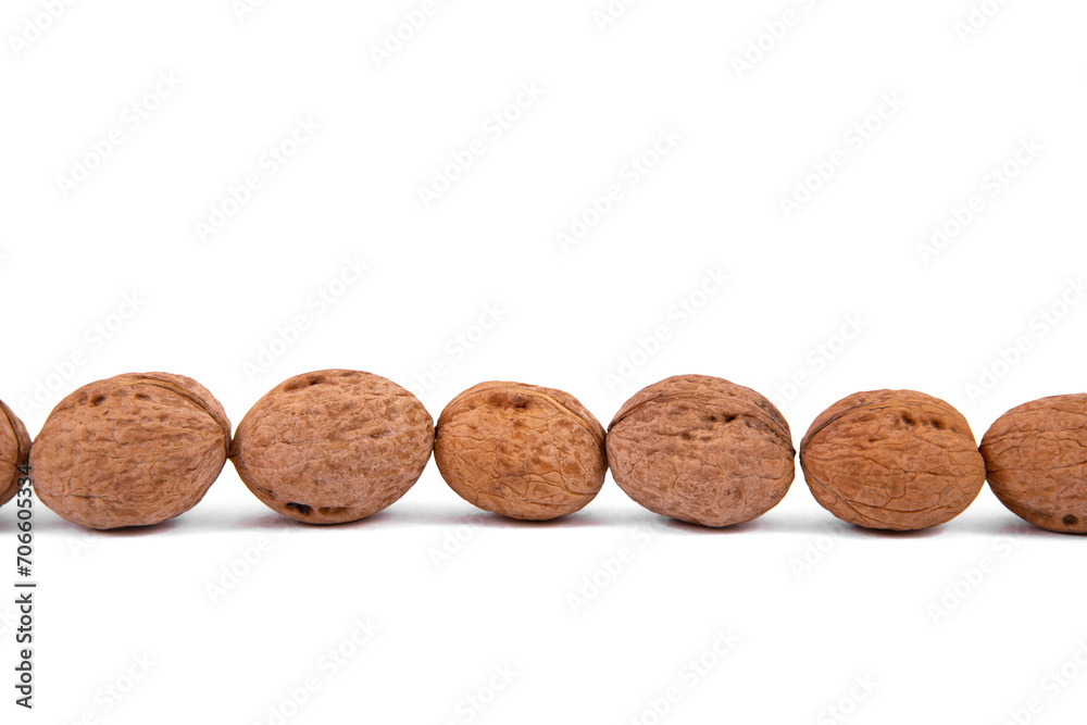 Scattered whole walnuts lie on a white background. Backgrounds and textures. Isolate. Scattered whole walnuts lie on a white background. Backgrounds and textures. Isolate.