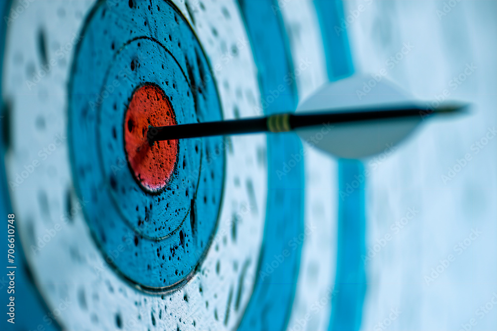 A white background featuring a blue and white target with an arrow at the center.
A white background featuring a blue and white target with an arrow at the center.