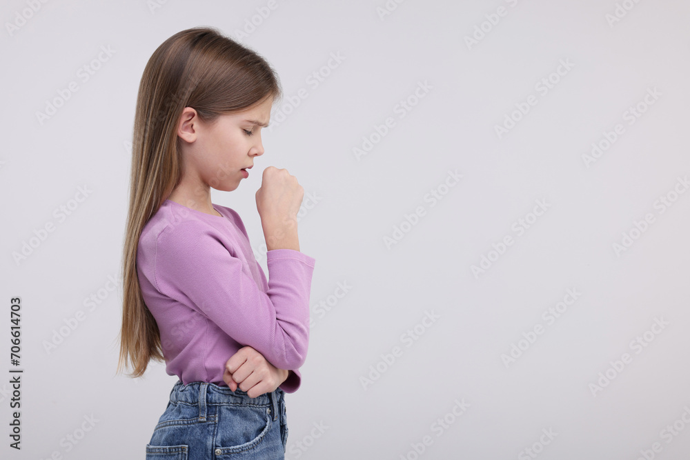 Sick girl coughing on light background, space for text Sick girl coughing on light background, space for text
