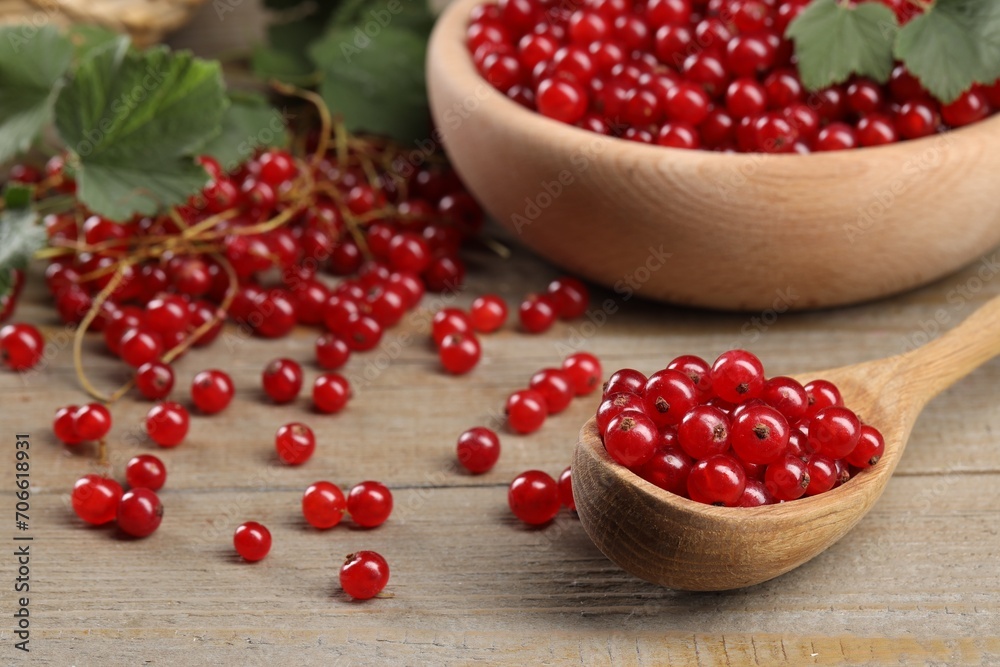Ripe red currants and leaves on wooden table Ripe red currants and leaves on wooden table