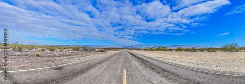 Panoramic picture of a lonely road through mountainous desert