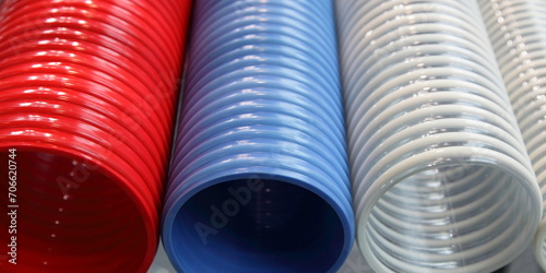 New colorful plastic spiral hoses closeup. A lot helical reinforced pipes industrial production