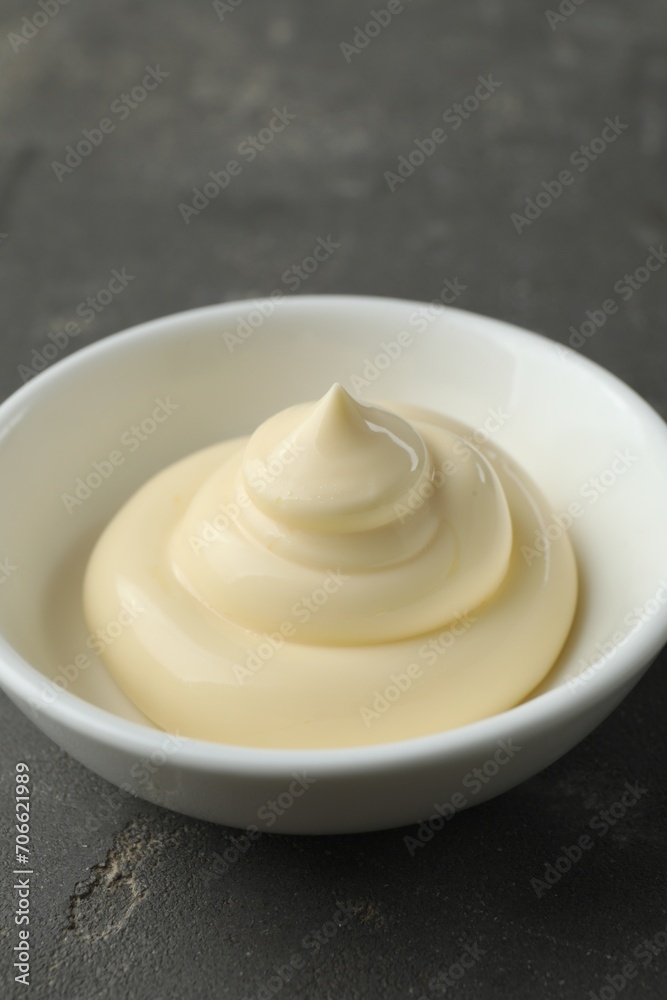 Fresh mayonnaise sauce in bowl on grey table, closeup Fresh mayonnaise sauce in bowl on grey table, closeup