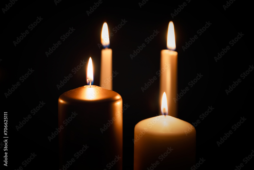 Candles burning in darkness over black background Candles burning in darkness over black background
