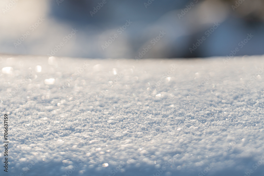 Snowy background for the product. Snow close-up, macro. Snowy field on a sunny day Snowy background for the product. Snow close-up, macro. Snowy field on a sunny day