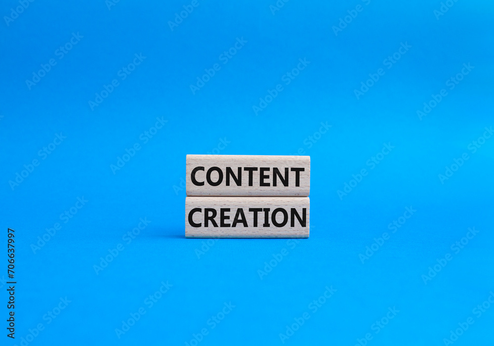 Content creation symbol. Concept word Content creation on wooden blocks. Businessman hand. Beautiful blue background. Business and Content creation concept. Copy space