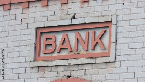 Close up of vintage architecture with old cream bricks and a retro, vintage sign with the word bank