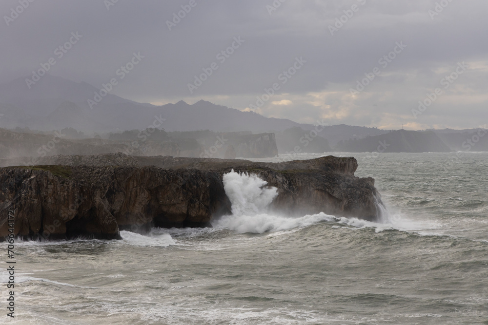 Bufones de Pria in Asturias coast on a cloudy day with rough seas and wave spray
