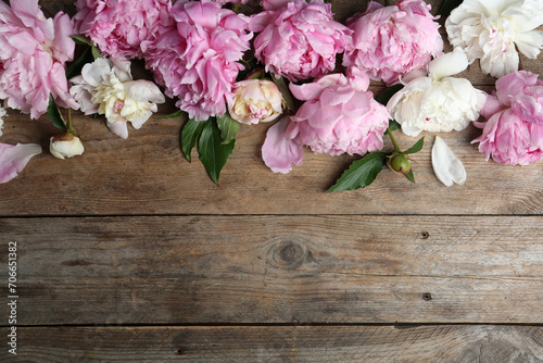 Beautiful peonies on wooden table, flat lay. Space for text © New Africa