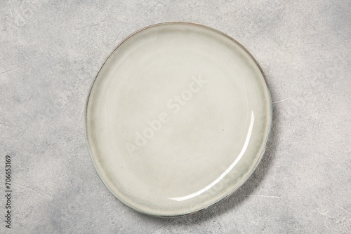 One ceramic plate on light table, top view