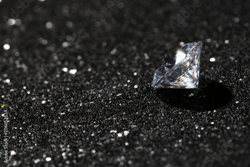 Beautiful dazzling diamond on dark shiny background. Space for text