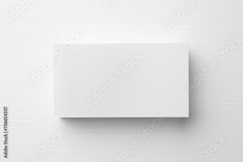 Stack of blank business cards on white table, top view. Mockup for design © New Africa