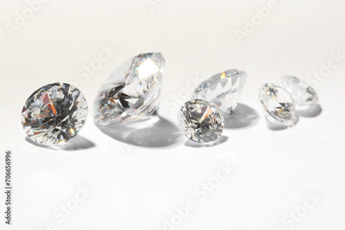 Many beautiful shiny diamonds on white background