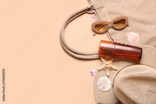 Composition with bottle of sunscreen cream, beach accessories and seashells on color background. Melanoma concept