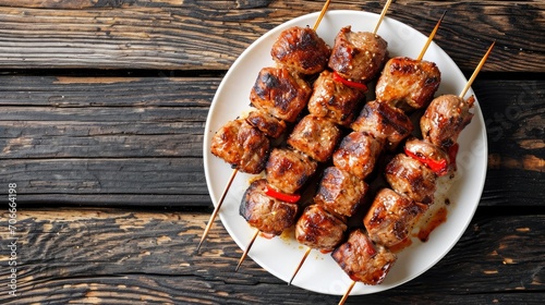 Meat barbecue on  skewers kebab, traditional turkish kebab n white plate on wooden table. photo