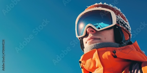 Close-Up of a Male Skier with Snow-Covered Goggles and Orange Jacket © romanets_v