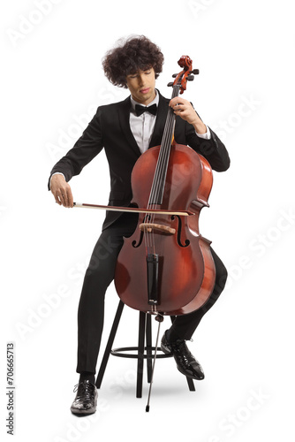 Young male cellist sitting on a chair and performing