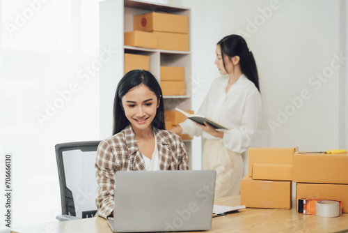 Two asian women with startup small business entrepreneur freelance working at home. checking product order. Online woman sellers working for e- © Nittaya