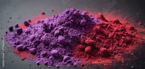  a pile of purple and red powder next to each other on a gray surface with a red light in the background.