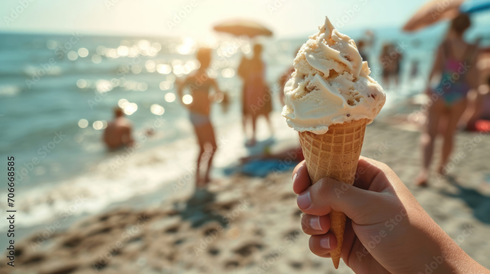 A person holds a vanilla gelato cone on a sunny beach with friends and family in the background, capturing a perfect summer day.