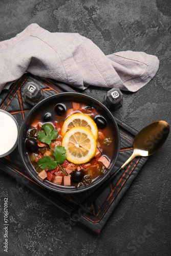 Bowl of tasty Hodgepodge soup on dark background photo