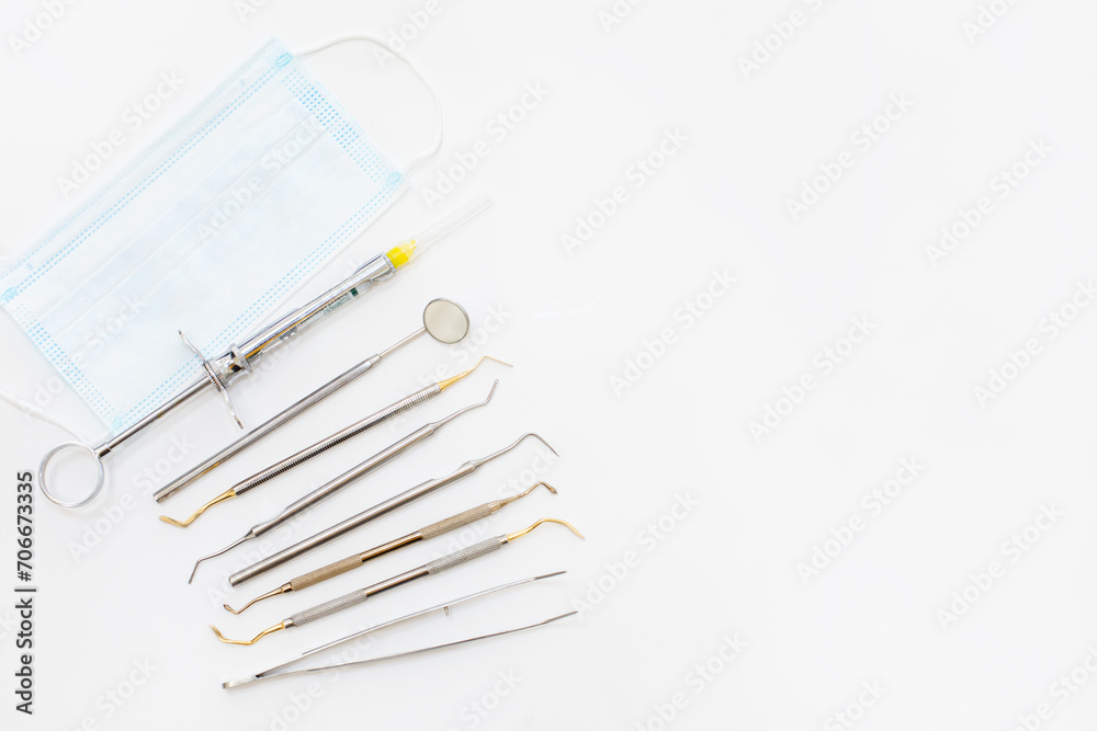 Naklejka premium Dental examination concept. Tooth shaped holder, dentist tools, toothbrush and face mask on white background, flat lay.