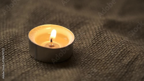 Small candle on sackcloth