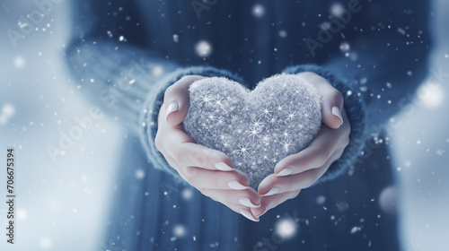 Winter snow christmas Valentine background greeting card - Closeup of woman holding a heart in her hands, defocused blurred background with snowflakes