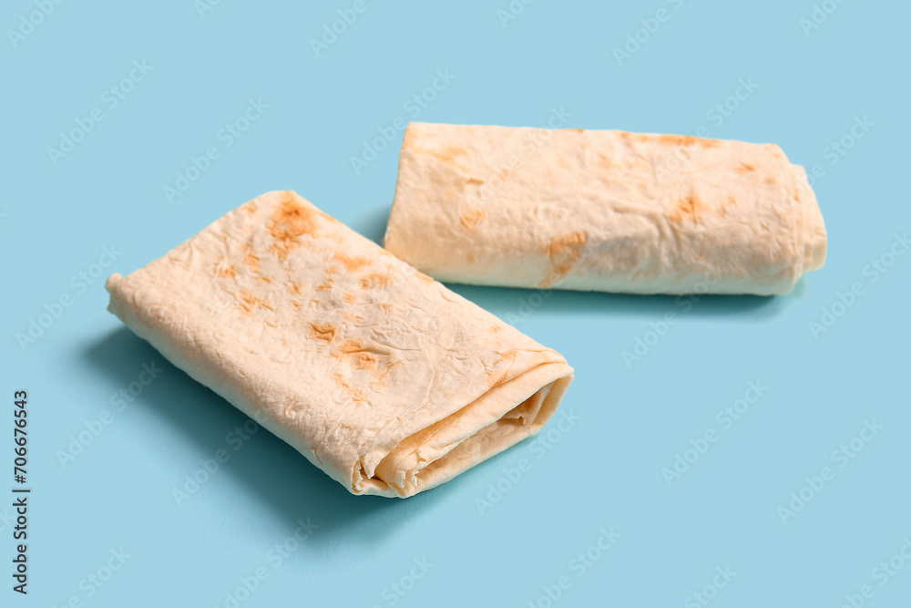 Fresh thin lavash on blue background