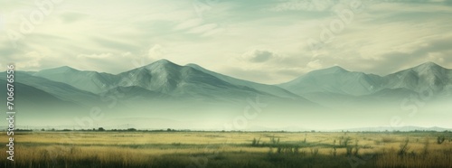 a blurring image of a field and mountains