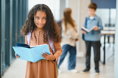 Portrait of cute African-American girl at school