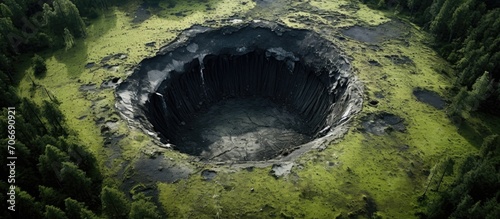 Bomb craters in the forest captured by aerial drone photography.