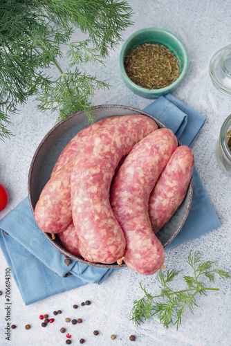 Raw pork sausages in cerami...
