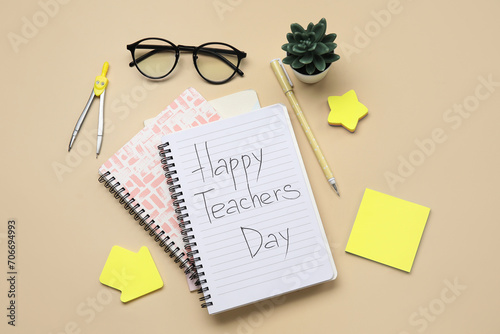 Notebooks with text HAPPY TEACHERS DAY, eyeglasses and stationery on beige background