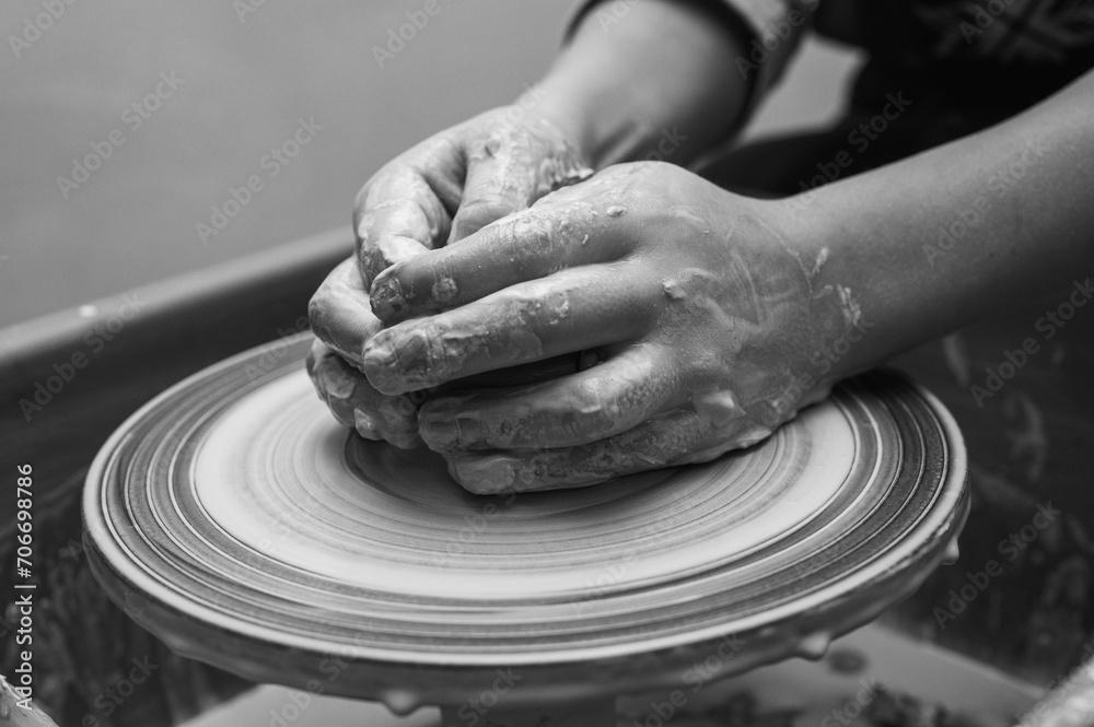 Black and white photo, clay, ceramics or hands in a design workshop working on an artistic cup or mug in a small business studio. Makes crafts in sculpture Black and white photo, clay, ceramics or hands in a design workshop working on an artistic cup or mug in a small business studio. Makes crafts in sculpture