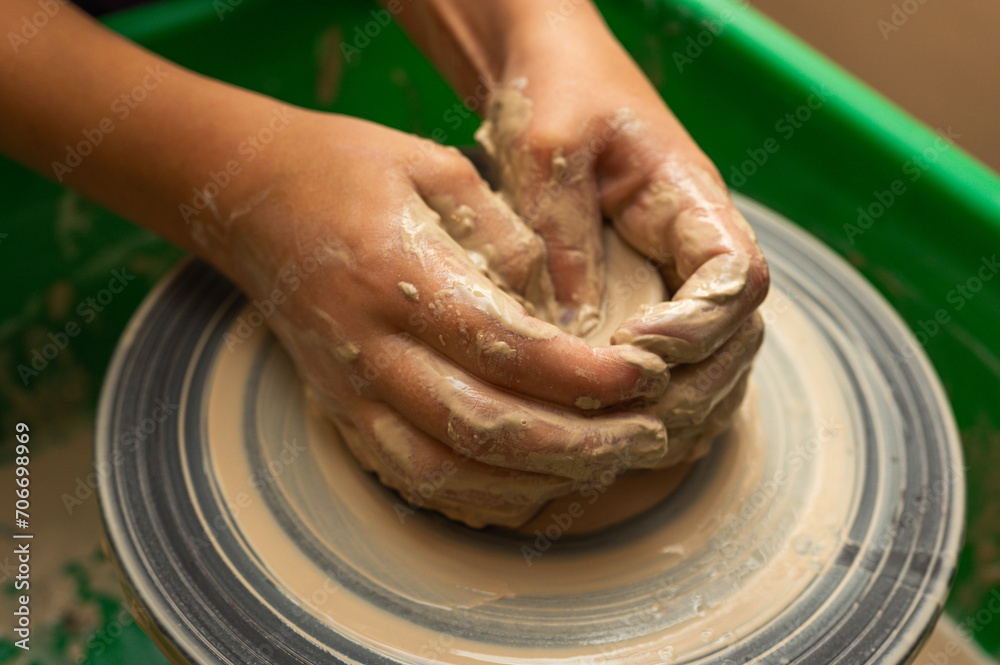 Clay, ceramics or hands in a design workshop working on an artistic cup or mug. The hand of a creative artist or worker making crafts in sculpture